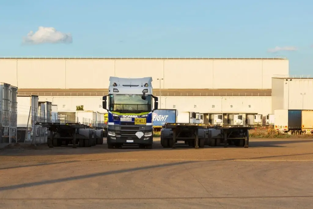 delivery trucks fleet outside warehouse